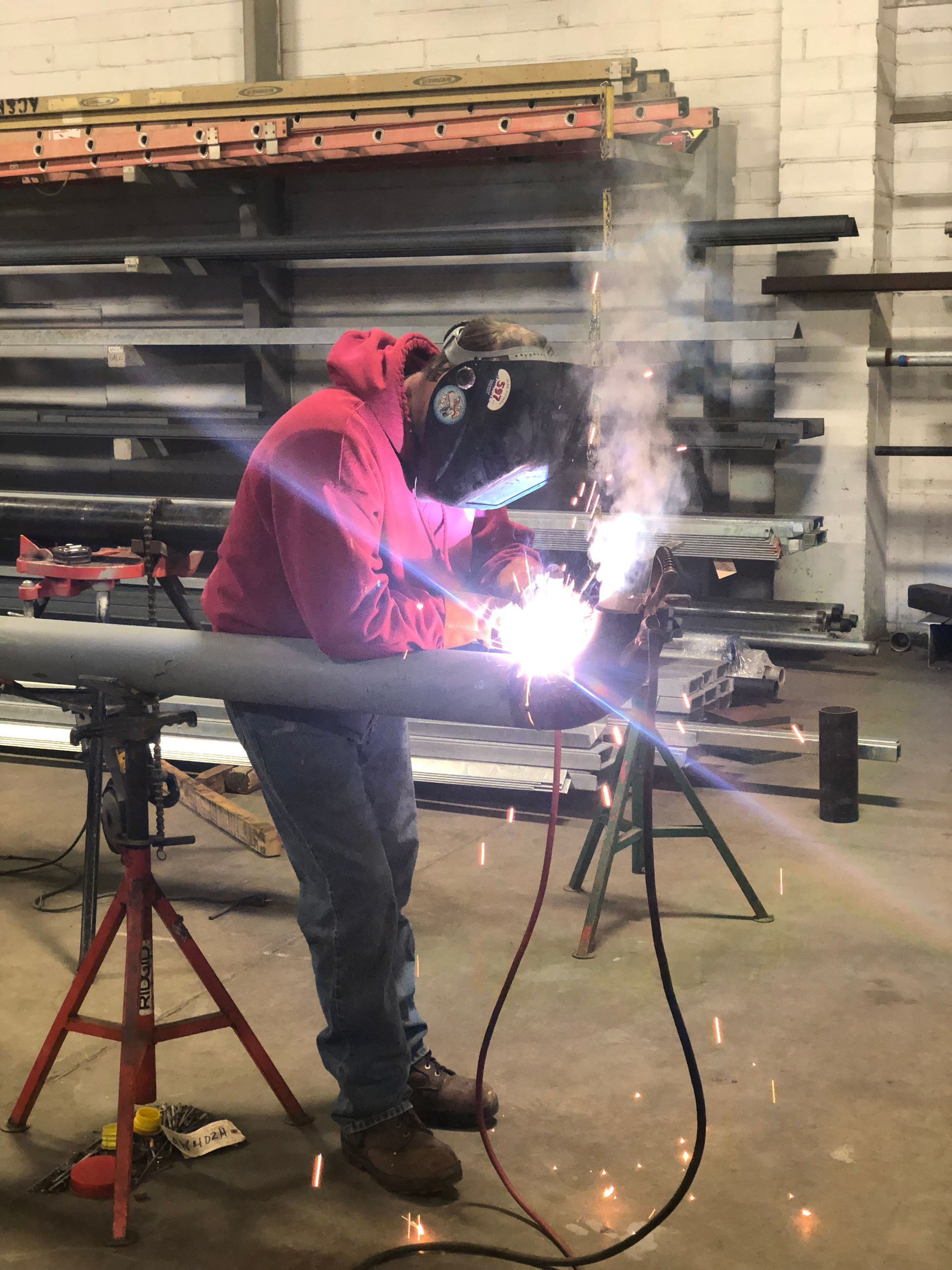 Person welding on piping